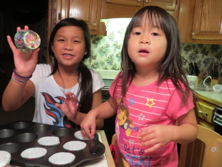 Karis and Kasen helping make birthday cupcakes